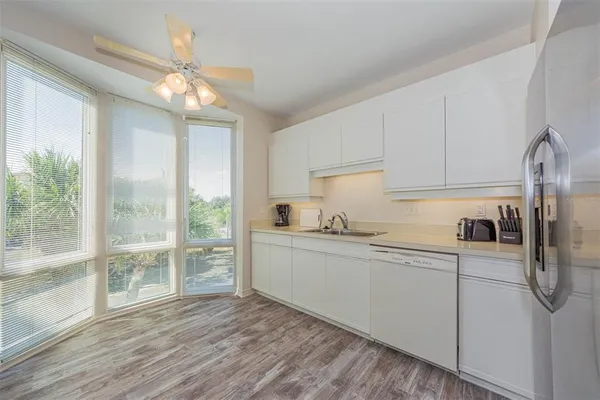 a kitchen with stainless steel appliances a refrigerator sink and cabinets