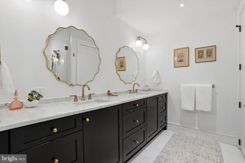 a bathroom with a double vanity sink and a mirror