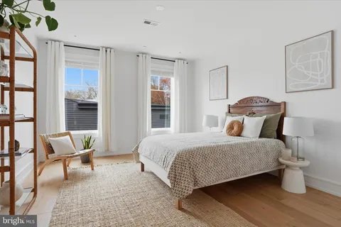 a bedroom with a bed and chair