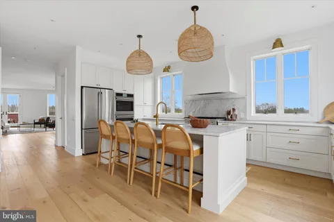 a kitchen with cabinets and chairs