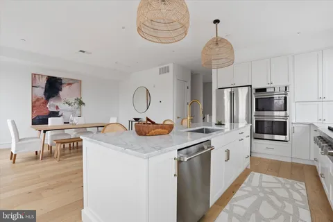 a view of a kitchen center island and appliances