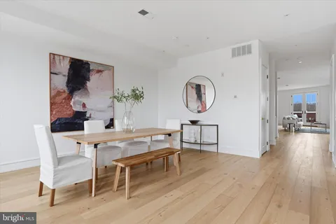 a living room with furniture a rug and a wall painting