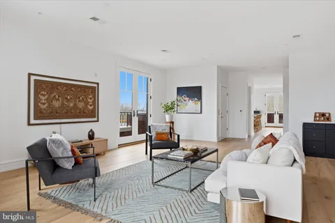 a living room with furniture a rug and a lamp