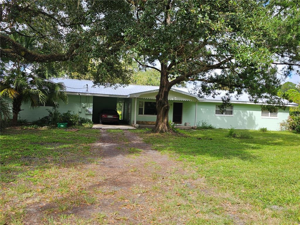 560 County Road 65 Bunnell, FL 32110 - Photo 1 of 1 a view of a house with a yard and a large tree