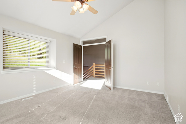 7396 Brook Hollow Loop Road Park City, UT 84098 - Photo 20 of 60 Vaulted ceiling, ceiling fan with integrated lighting, carpeted flooring, window with blinds, and double panel doors