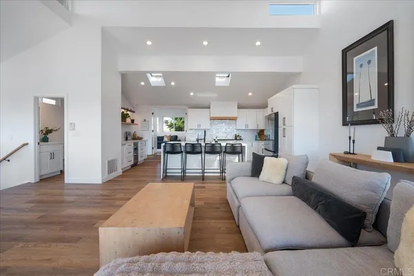 a kitchen with stainless steel appliances kitchen island granite countertop a refrigerator and a stove top oven