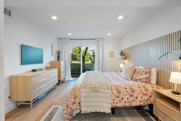 a bedroom with a large bed and a large window