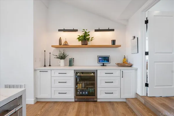 a kitchen with cabinets appliances and a wooden floor