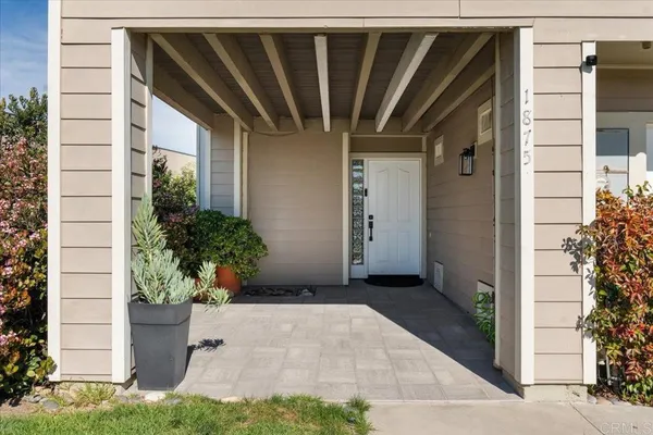 a view of a house with potted plants