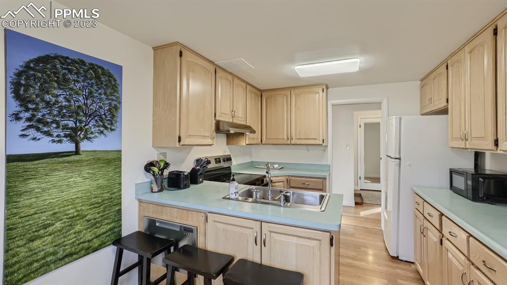 530 Valley Road Colorado Springs, CO 80904 - Photo 11 of 50 a kitchen with stainless steel appliances granite countertop a refrigerator sink and cabinets