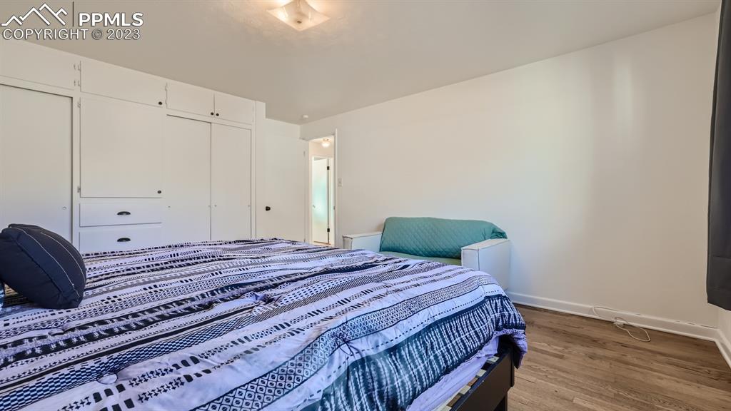 530 Valley Road Colorado Springs, CO 80904 - Photo 17 of 50 a bedroom with a bed and wooden floor