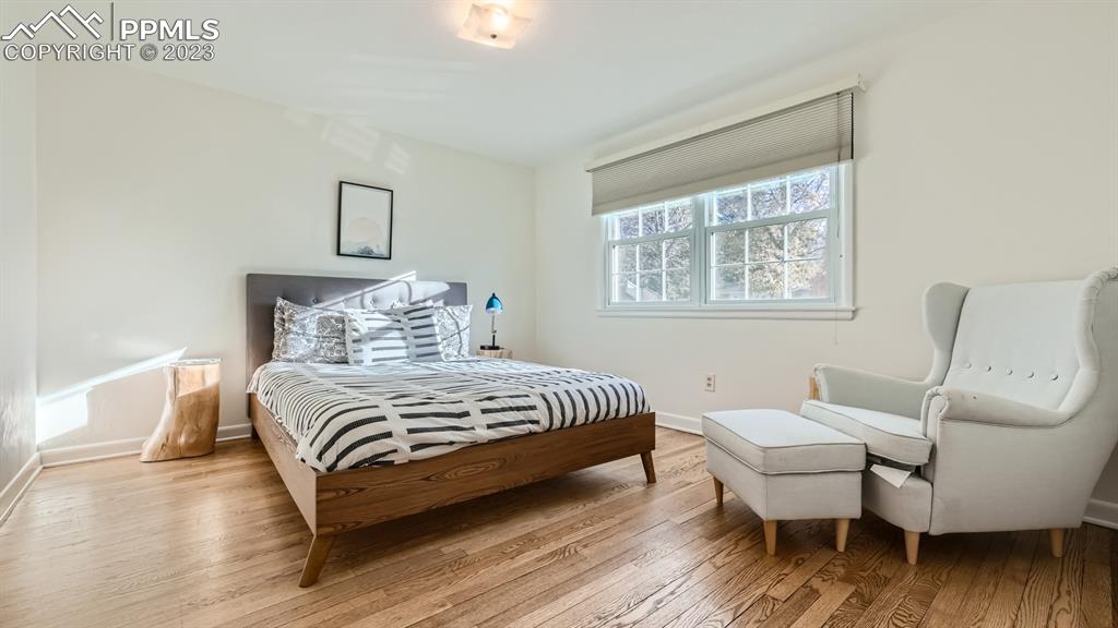 530 Valley Road Colorado Springs, CO 80904 - Photo 22 of 50 a bedroom with a bed and wooden floor