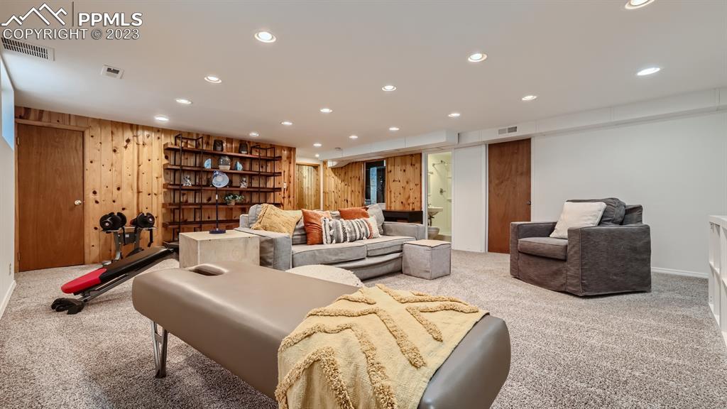 530 Valley Road Colorado Springs, CO 80904 - Photo 29 of 50 a living room with furniture and a gym with wooden floor