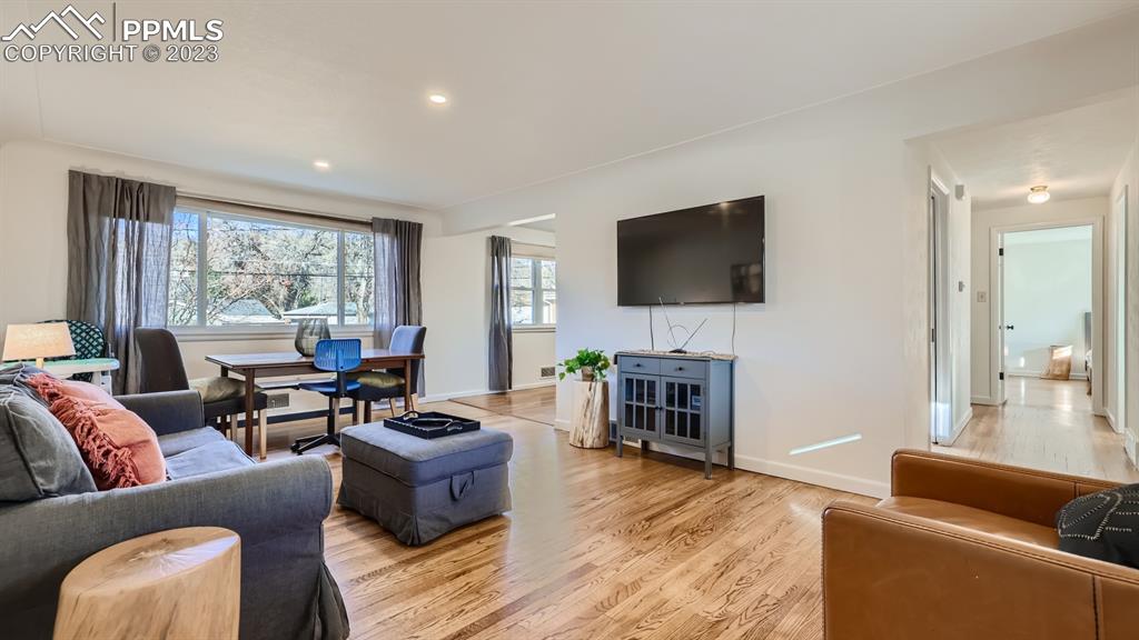 530 Valley Road Colorado Springs, CO 80904 - Photo 5 of 50 a living room with furniture a fireplace and a flat screen tv