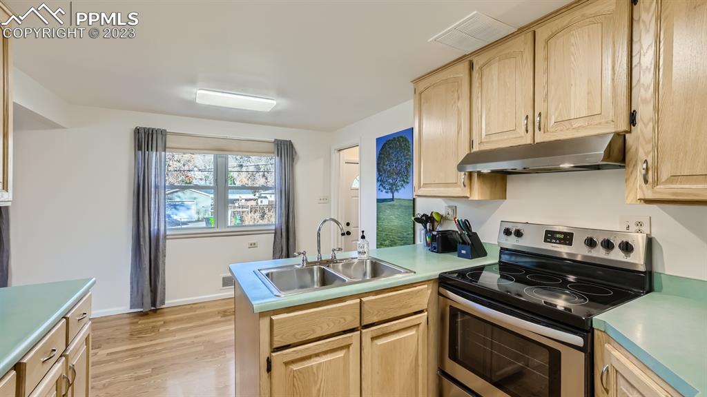 530 Valley Road Colorado Springs, CO 80904 - Photo 9 of 50 a kitchen with stainless steel appliances granite countertop a sink stove and cabinets