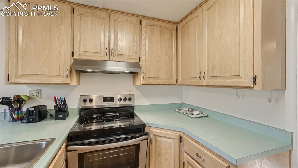 530 Valley Road Colorado Springs, CO 80904 - Photo 10 of 50 a kitchen with granite countertop white cabinets and stainless steel appliances