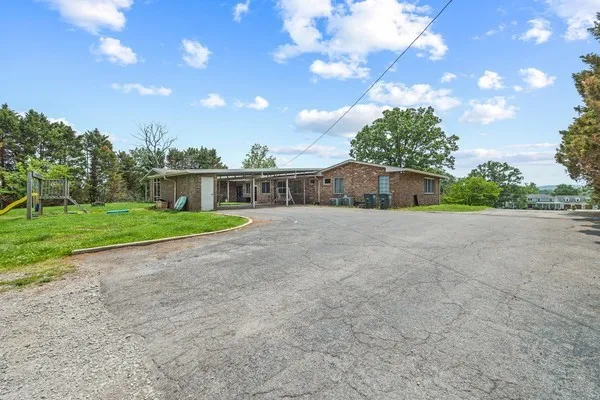 a living room with stainless steel appliances furniture and a kitchen