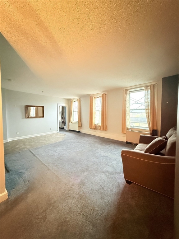 140 Chestnut Street, Unit 604 Springfield, MA 01103 - Photo 10 of 21 a living room with furniture and a window