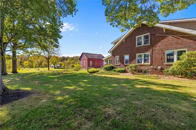 a front view of house with yard and green space