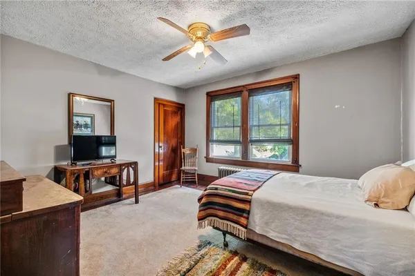 a bedroom with a bed and a table in it