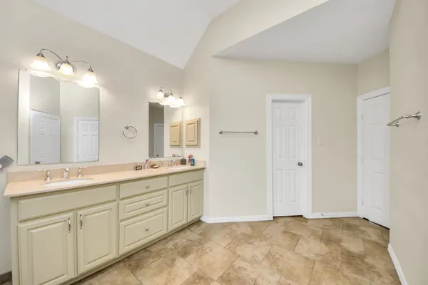 a bathroom with a double vanity sink mirror and