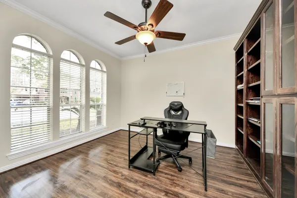 a workspace with wooden floor and a window