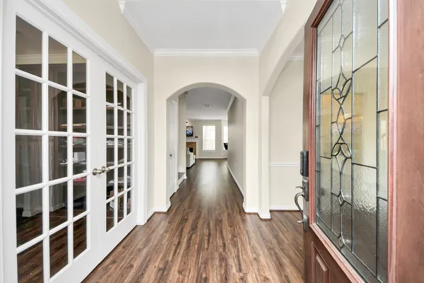a view of a room with wooden floor and windows