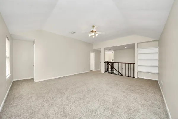 a view of a livingroom with a ceiling fan and window