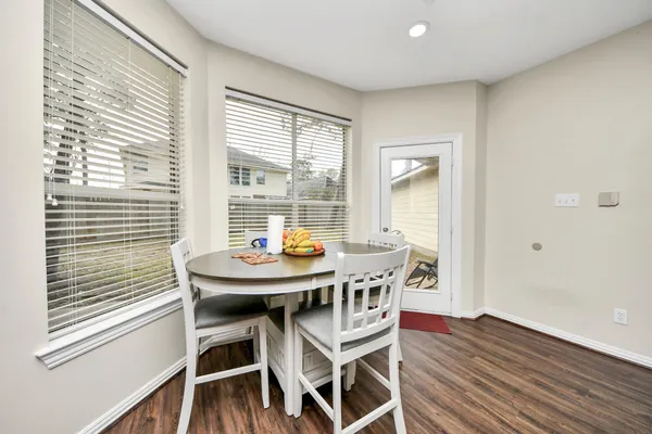 a view of a dining room with furniture and wooden floor