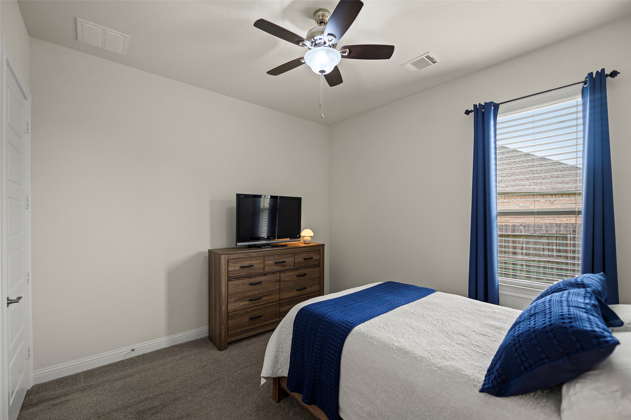 20330 Rosegold Way Spring, TX 77379 - Photo 29 of 48 Comfortable secondary bedroom with abundant natural light and neutral finishes.