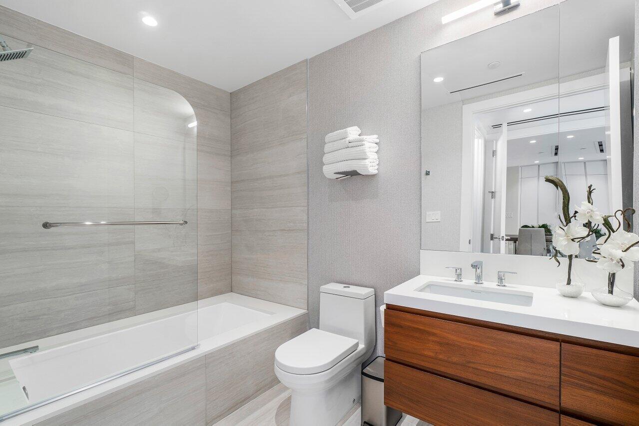 200 Southeast Mizner Boulevard, Unit 211 Boca Raton, FL 33432 - Photo 25 of 67 a bathroom with a sink a toilet and shower