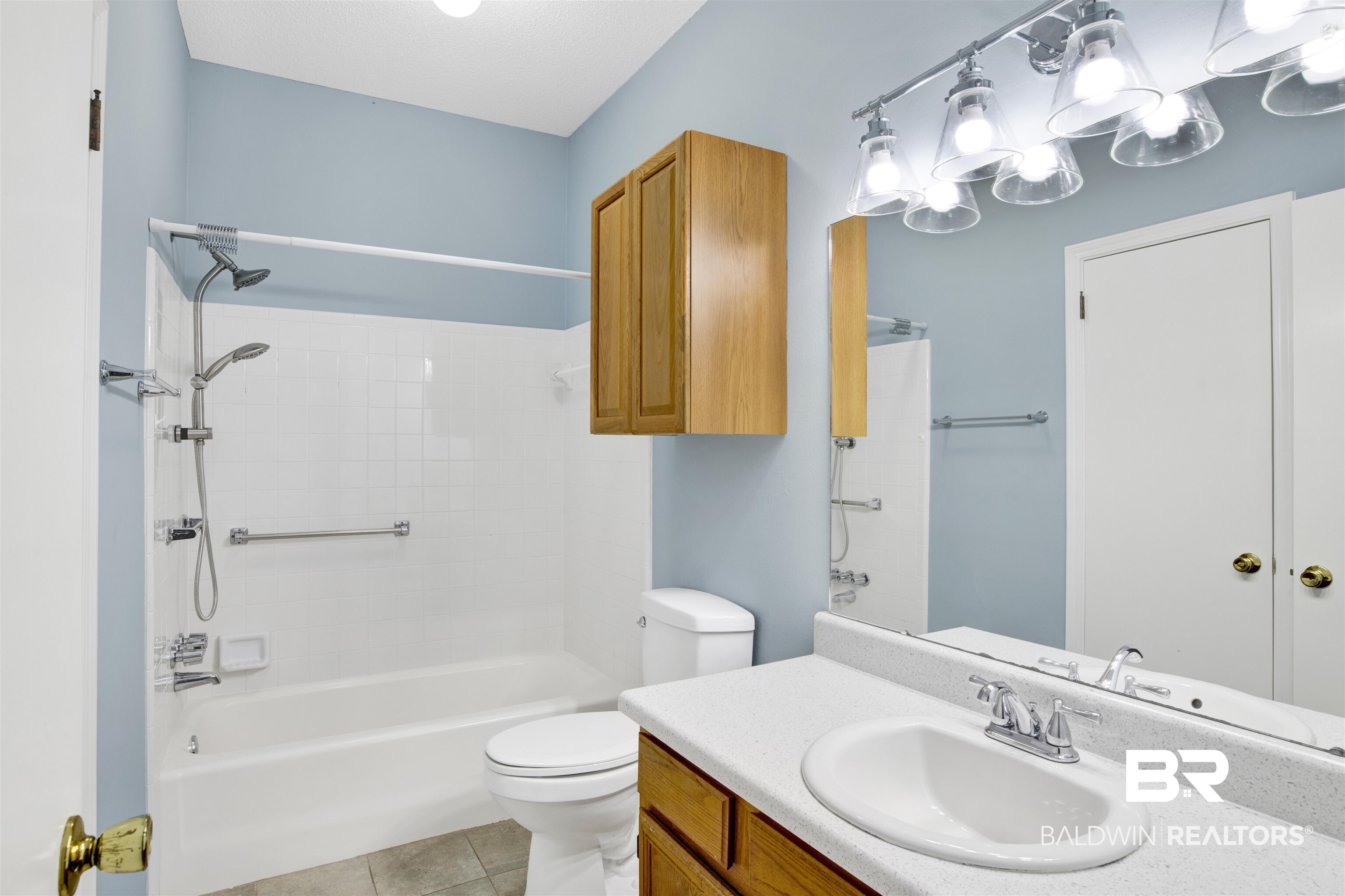1258 Sutton Court, Unit 4 Mobile, AL 36609 - Photo 16 of 19 Full bath featuring vanity, tile patterned flooring, toilet, and shower combination
