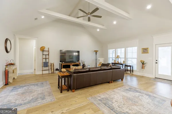 a kitchen with a sink a stove a dining table and chairs