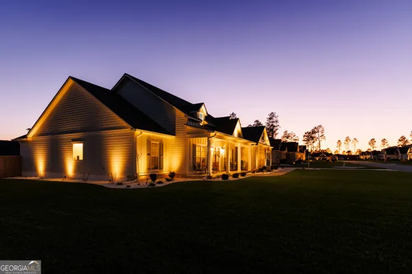 a backyard of a house with table and chairs