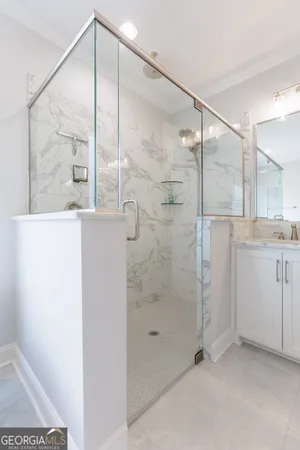 a bathroom with a granite countertop sink toilet and a mirror