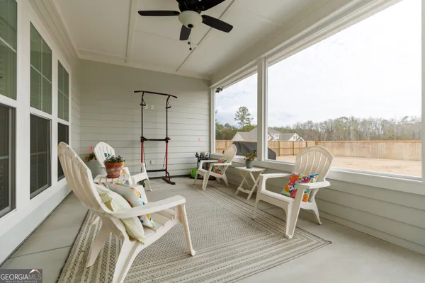 a view of a swimming pool with a table and chairs under an umbrella