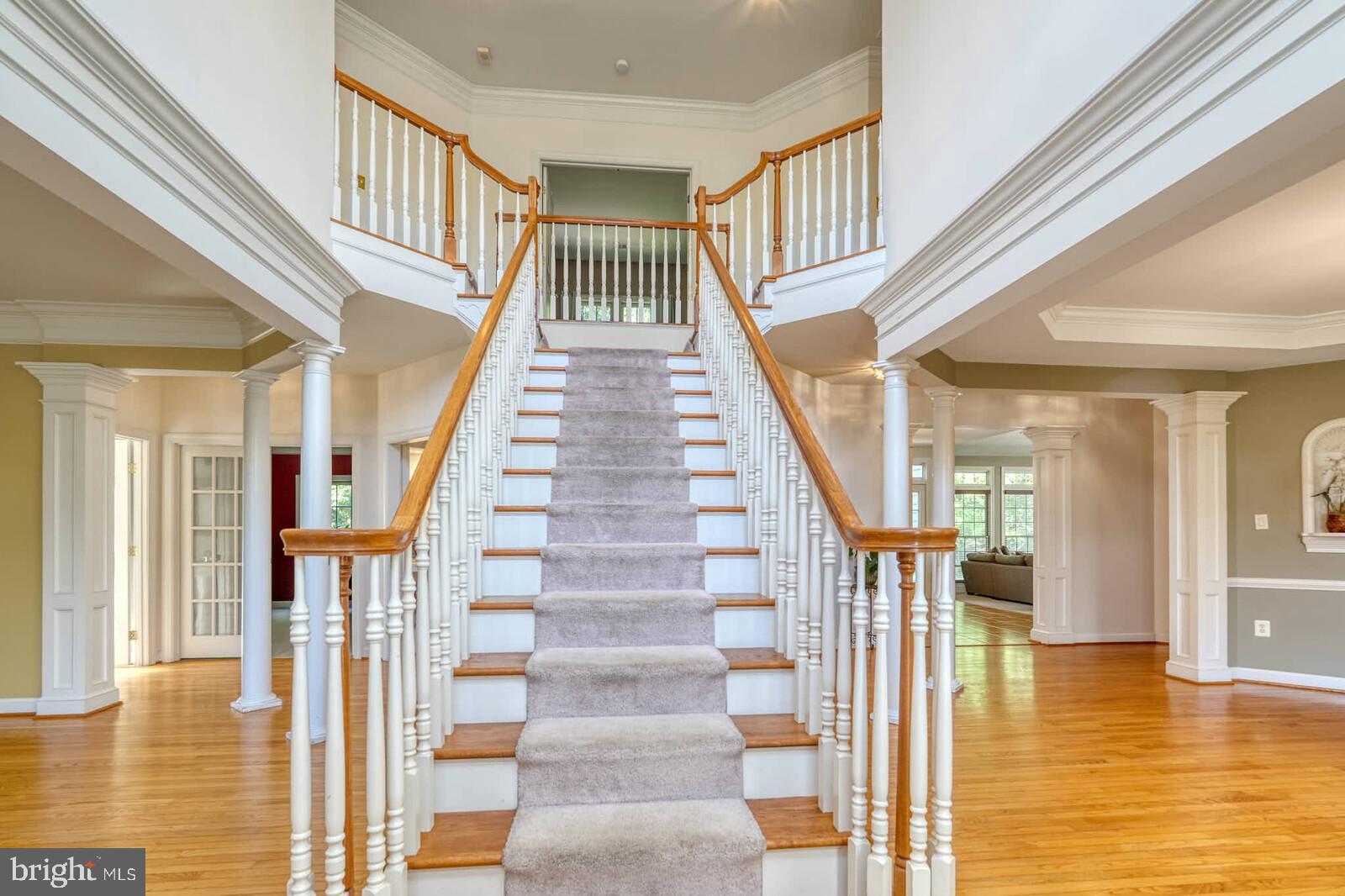 13014 English Turn Drive Silver Spring, MD 20904 - Photo 2 of 10 a view of staircase with lots of frames on wall and a dining table next to a large window