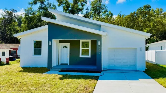 a view of house with backyard space and garden