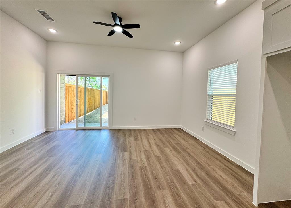 1811 Washington Street Commerce, TX 75428 - Photo 28 of 36 wooden floor in an empty room with a window