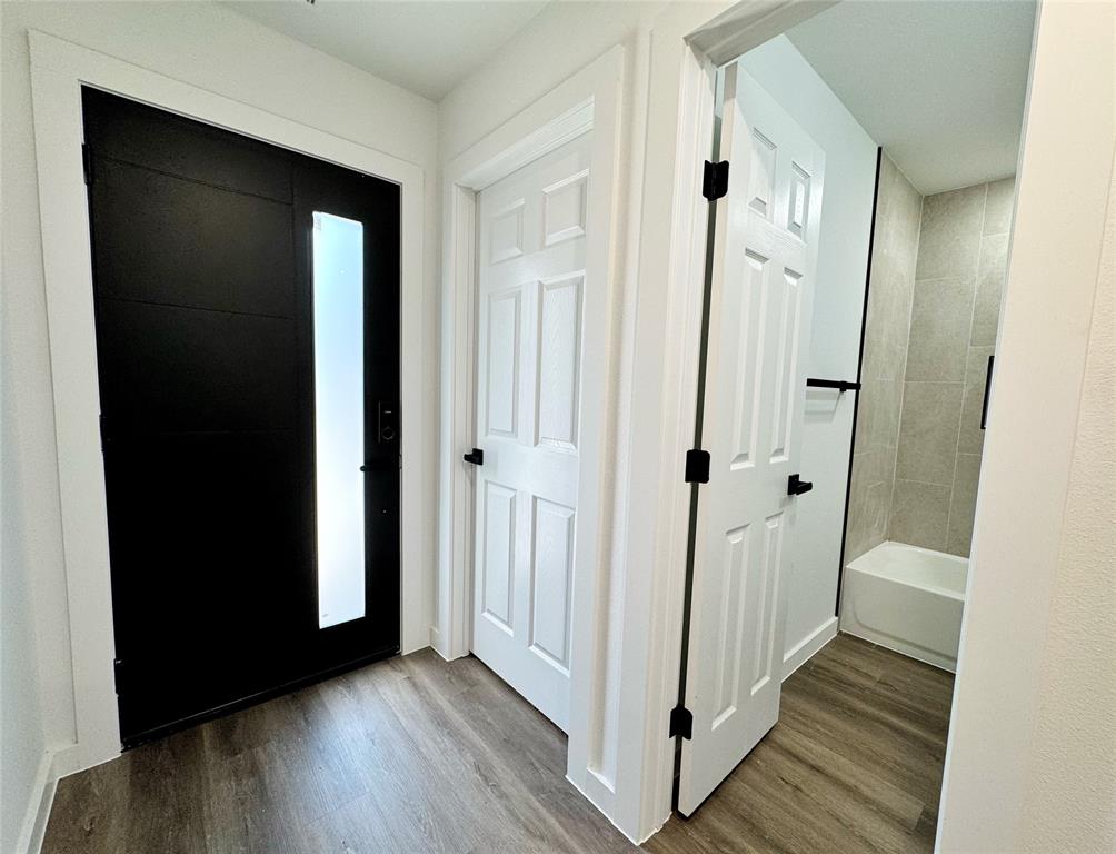 1811 Washington Street Commerce, TX 75428 - Photo 5 of 36 a view of a hallway with wooden floor