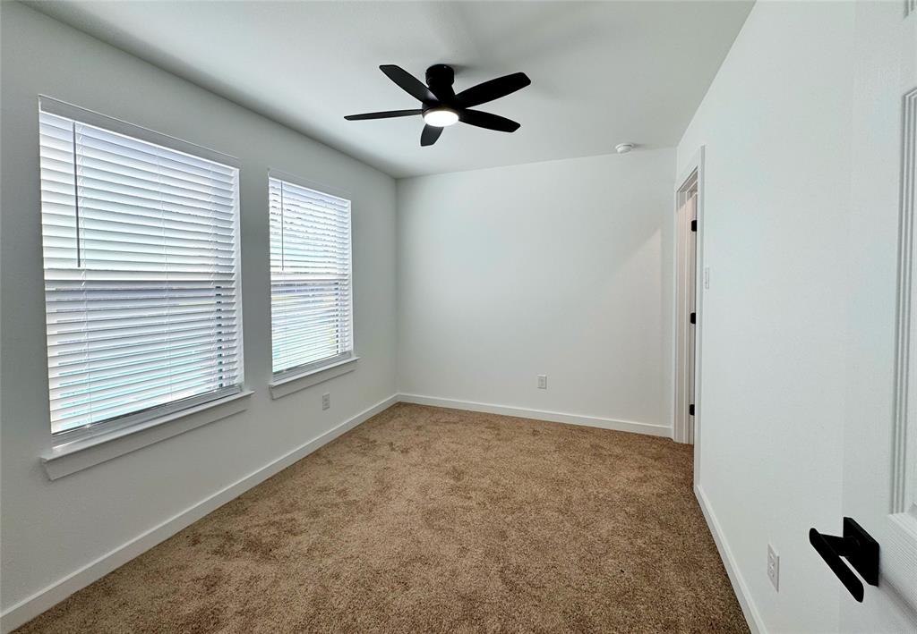 1811 Washington Street Commerce, TX 75428 - Photo 6 of 36 a view of empty room with ceiling fan and window