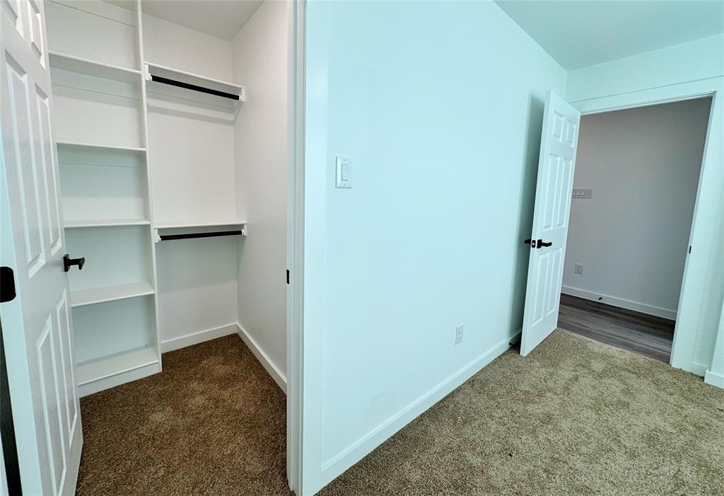 1811 Washington Street Commerce, TX 75428 - Photo 7 of 36 a view of walk in closet with empty racks