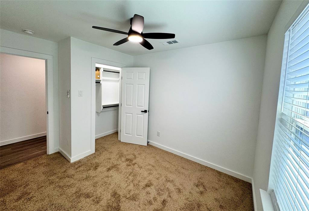 1811 Washington Street Commerce, TX 75428 - Photo 8 of 36 an empty room with closet and windows