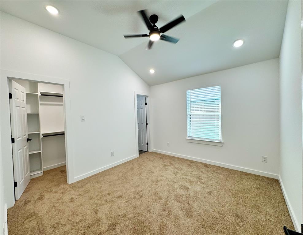 1811 Washington Street Commerce, TX 75428 - Photo 9 of 36 an empty room with a window and a ceiling fan