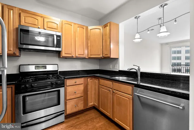 a kitchen with granite countertop a stove and a microwave