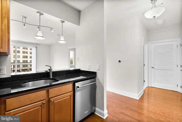 a kitchen with granite countertop a sink and cabinets