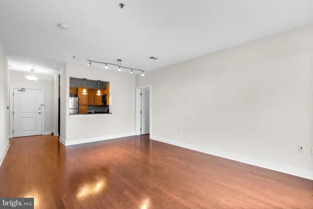 a view of an empty room with wooden floor