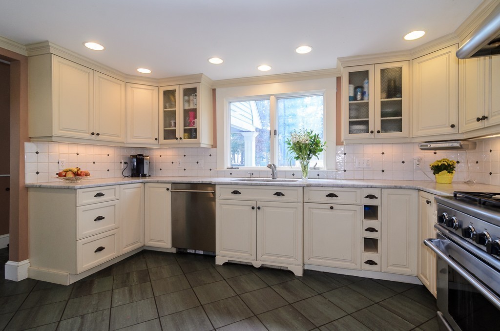 30 Birch Road Natick, MA 01760 - Photo 4 of 21 a kitchen with white cabinets appliances and a window