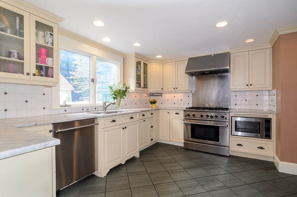 30 Birch Road Natick, MA 01760 - Photo 5 of 21 a kitchen with granite countertop a sink stove top oven and cabinets