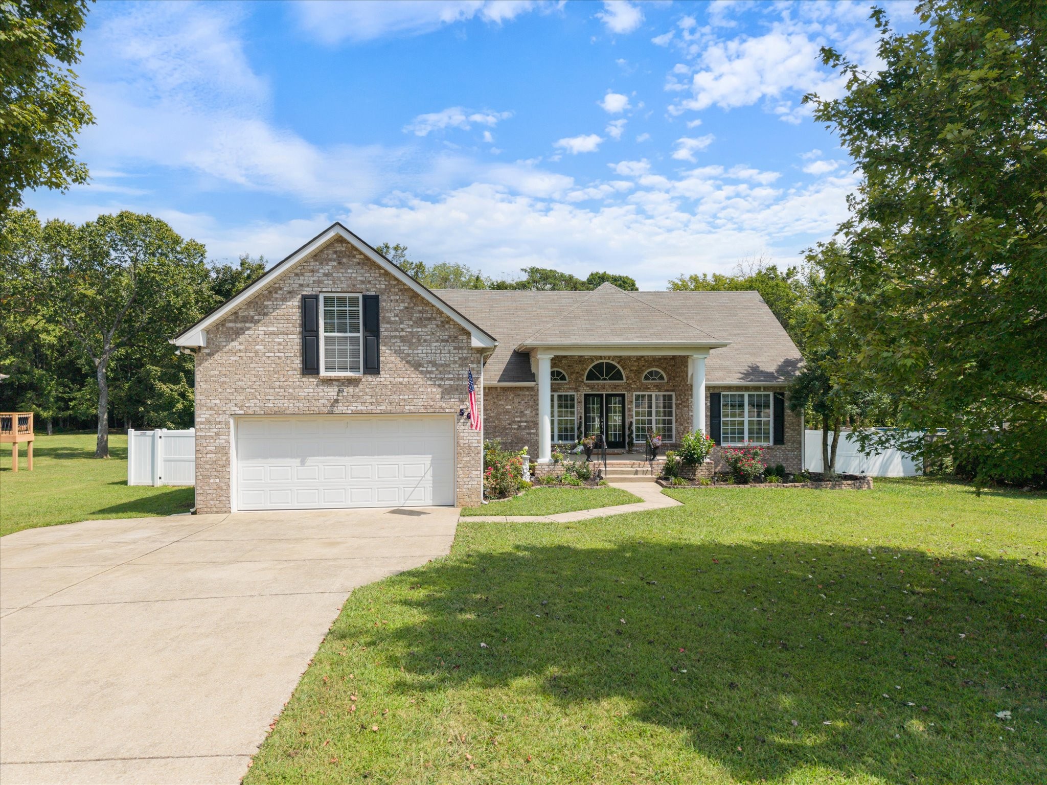 560 Windy Road Mount Juliet, TN 37122 - Photo 1 of 40 a front view of a house with a garden and porch